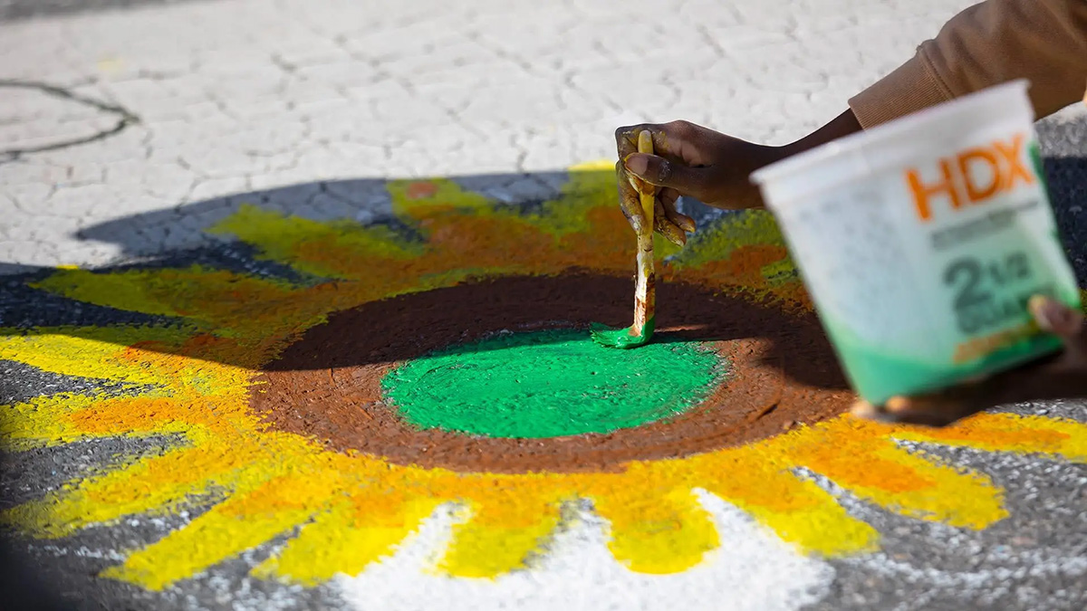 Closeup of someone painting a sun