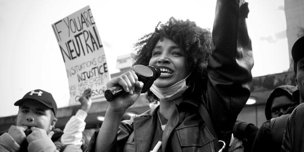 Woman speaking at a social justice protest