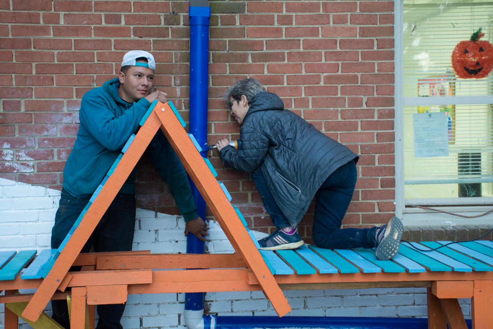 Ronit Eisenbach and contractor working on a Lightscape rain garden bench.