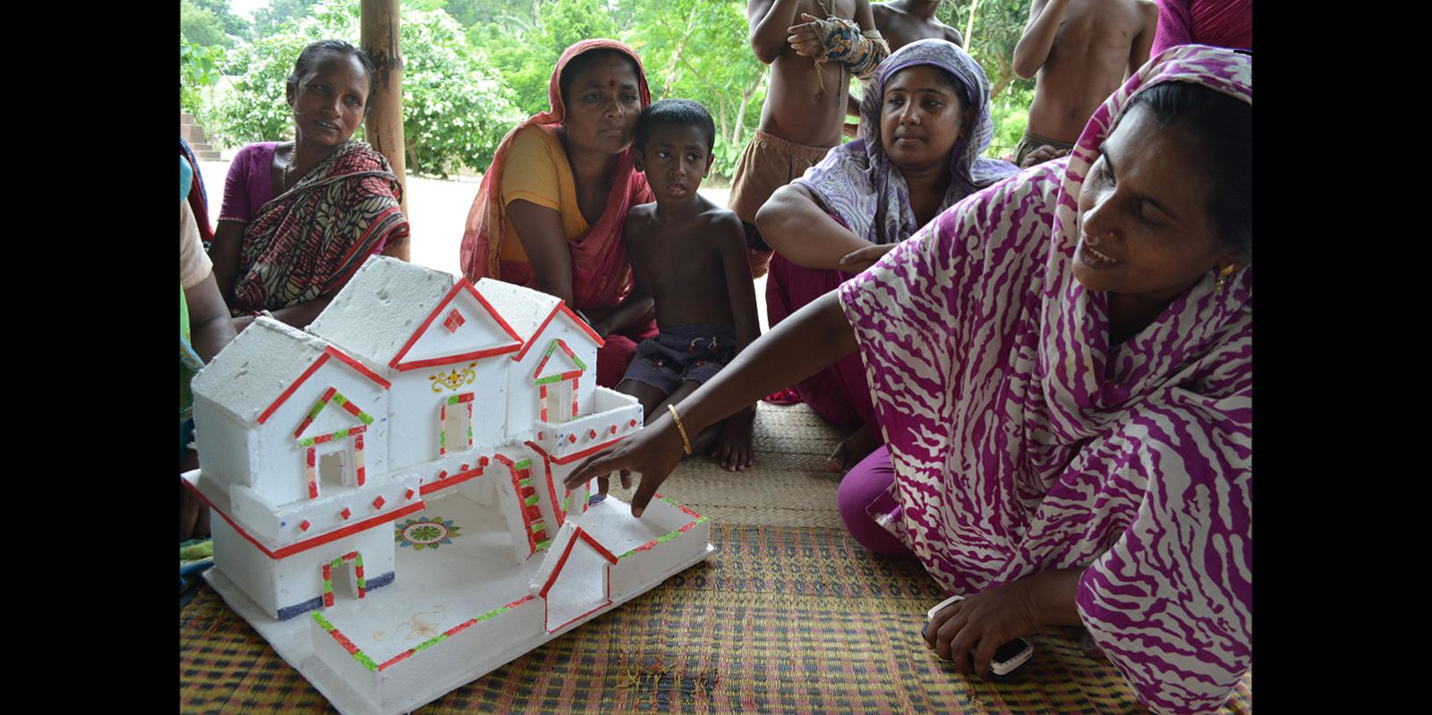 Woman showing an architecture model to a community