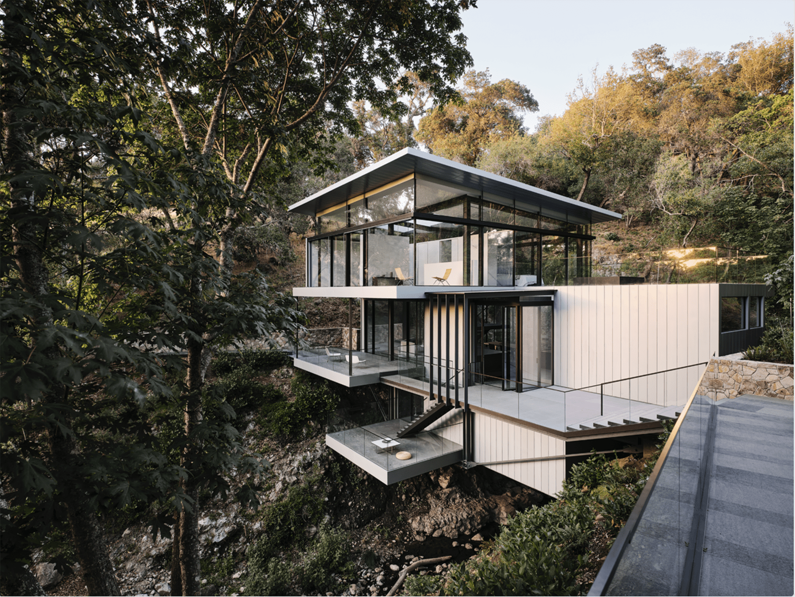 A house suspended on rocks in a forest landscape