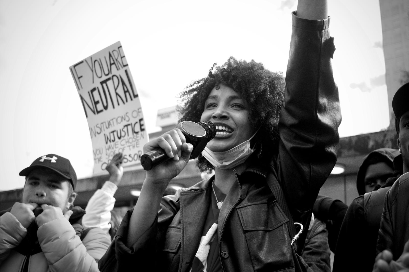 Woman speaking at a social justice protest