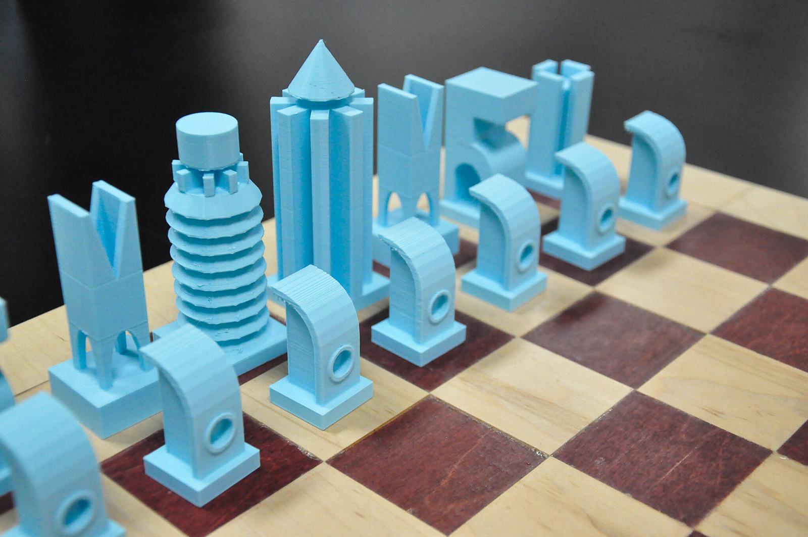 3D printed blue chessboard pieces in the shape of building